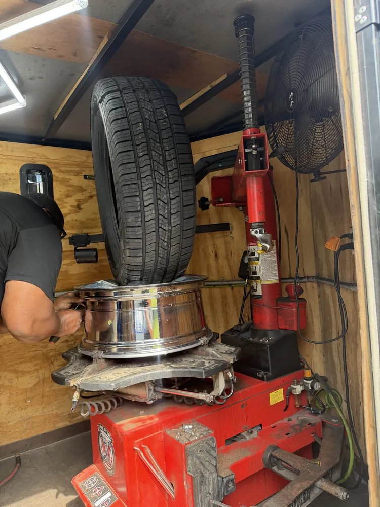New tire being mounted on the tire machine inside the Taylor Mobile Tire Service trailer in Ocala, Florida